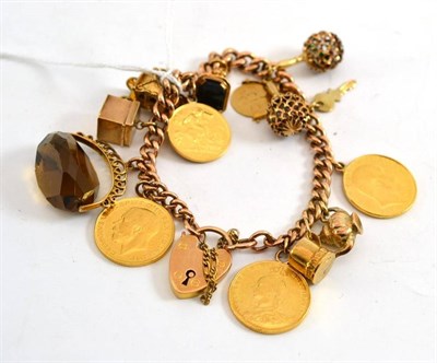 Lot 488 - A charm bracelet, hung with thirteen charms including 1911, 1892 and 1909 full sovereigns and a...