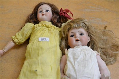 Lot 505 - Limoges bisque socket head doll with blue eyes, composition jointed body, wearing yellow dress; and