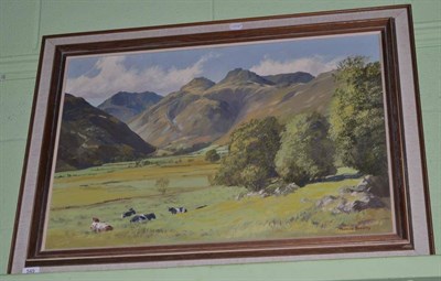 Lot 549 - Thomas Bradley, cows grazing in a lakeland landscape, signed, oil on canvas