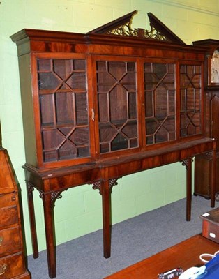 Lot 604 - A mahogany breakfront display cabinet, with astragal glazed doors, raised on associated table...