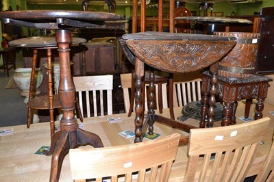 Lot 617 - A Georgian mahogany tilt-top tripod table, a carved oak swivel top drop-leaf table, a carved...