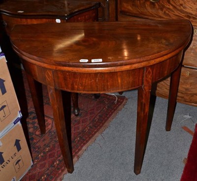 Lot 625 - A demi-lune mahogany fold-over tea table