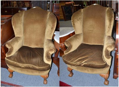 Lot 637 - A pair of Queen Anne style wing back armchairs with green upholstery