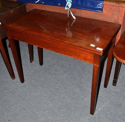 Lot 643 - A mahogany fold-over tea table