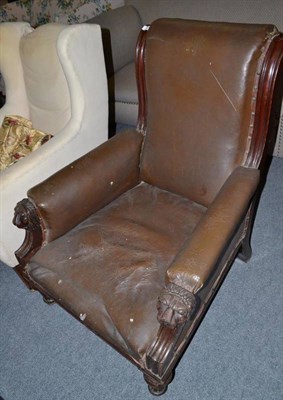 Lot 653 - A Victorian Rexine upholstered armchair with carved lion marks to the arms