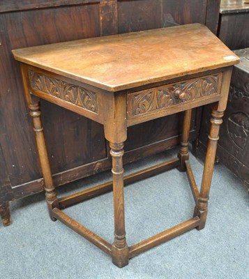 Lot 684 - A reproduction carved oak side table