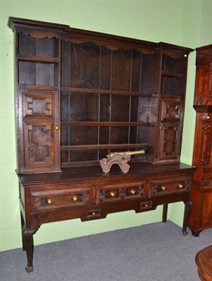 Lot 712 - An oak Welsh dresser and rack with panelled drawers and cupboards