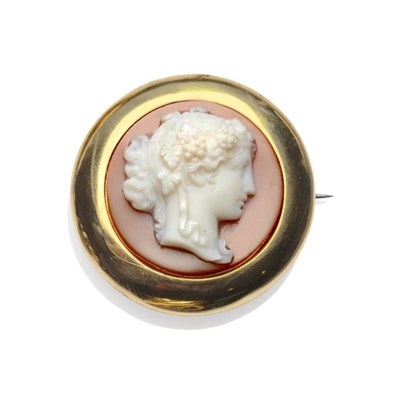 Lot 453 - A Hardstone Cameo Brooch, the circular hardstone carved with a portrait of Bacchus, in a plain...