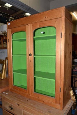 Lot 823 - A pine glazed cupboard