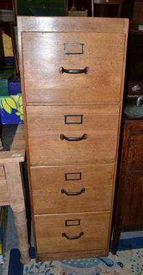 Lot 838 - A blonde oak four drawer filing cabinet