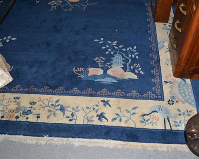 Lot 850 - Peking carpet, East China, the mid indigo field centred by a pagoda, the spandrels similar...