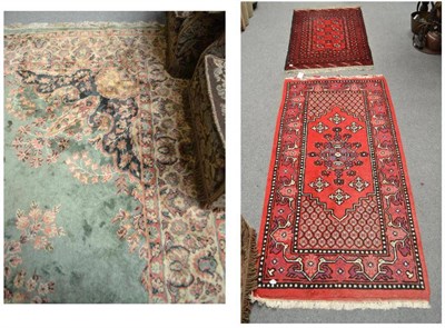 Lot 851 - Two small red ground rugs and one large green rug