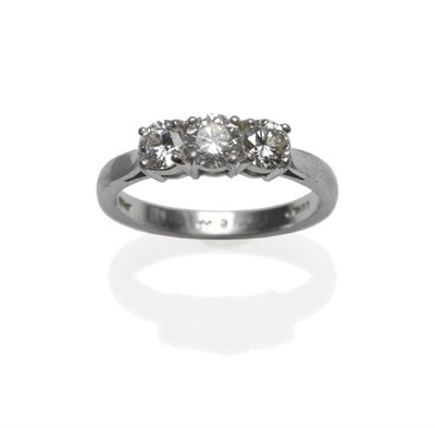 Lot 470 - A Platinum Diamond Three Stone Ring, the round brilliant cut diamonds in claw settings, on a...