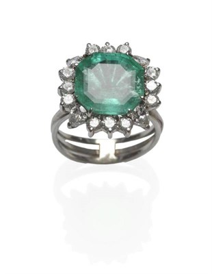 Lot 478 - An Emerald and Diamond Ring, the octagonal step cut emerald with a pear cut diamond to four...