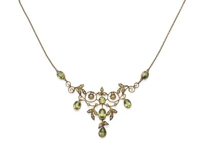 Lot 488 - A Peridot and Seed Pearl Necklace, circa 1900, the typical scrolling and floral motif inset...