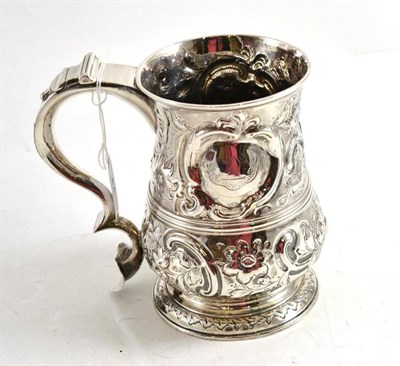 Lot 44 - A George III mug, London 1761, probably William & John Deane, with later embossed decoration