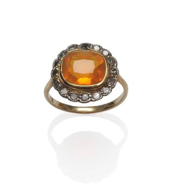 Lot 499 - A Fire Opal and Diamond Cluster Ring, the cushion cut fire opal in a yellow collet setting,...