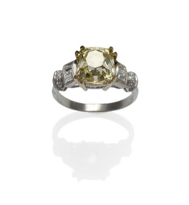 Lot 502 - A Yellow and White Diamond Ring, the fancy yellow modified square shaped diamond in yellow...