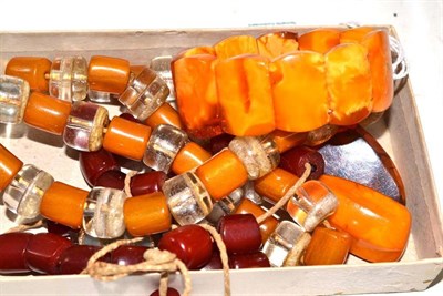 Lot 91 - An amber bracelet, two amber brooches, two necklaces, a damaged earring and two pendants