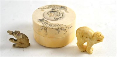 Lot 92 - Ivory cylindrical box and cover carved with tigers, and two carved monkeys (3)
