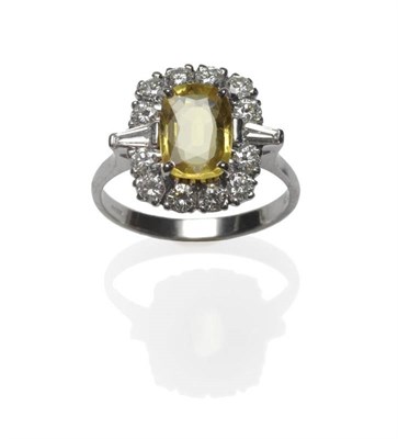 Lot 508 - An 18 Carat White Gold Yellow Sapphire and Diamond Cluster Ring, the cushion cut yellow...