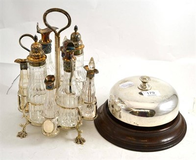 Lot 179 - A plated eight bottle cruet and a large table bell