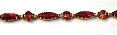 Lot 514 - A Foil Backed Garnet Bracelet, rose cut, marquise and oval shaped stones alternate along the...