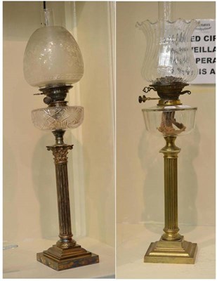 Lot 204 - A plated column oil lamp with glass well and another similar on a brass base