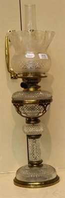 Lot 205 - A 19th century cut glass table lamp with brass mounts and etched shade