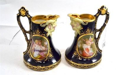 Lot 246 - A pair of Vienna porcelain ewers painted with Classical figures within gilt foliate borders on...