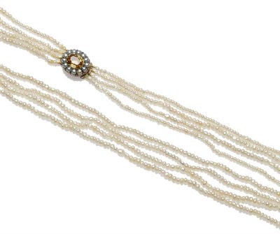 Lot 519 - A Seed Pearl Necklace, four strands of irregular shaped pearls strung to an oval clasp, of...