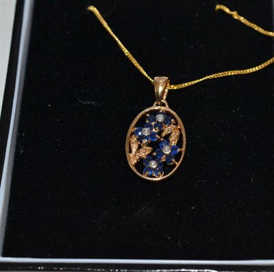 Lot 264 - A 9ct gold sapphire and diamond pendant on a 9ct gold chain