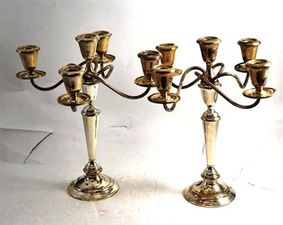 Lot 272 - A pair of sterling silver four branch candelabra, stamped Newport with screw-off tops