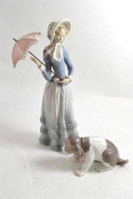 Lot 286 - Two Lladro figures: a lady with umbrella and a dog