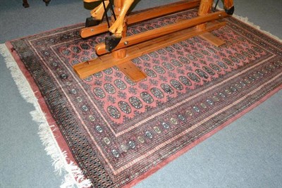 Lot 356 - A pink ground Eastern patterned carpet