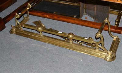 Lot 387 - Brass fire curb and brass fire irons