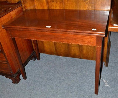 Lot 389 - A mahogany fold-over tea table