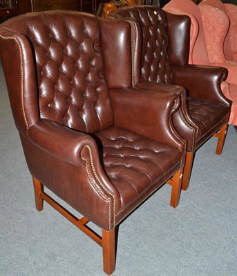 Lot 402 - Pair of modern brown leather button back wing armchairs