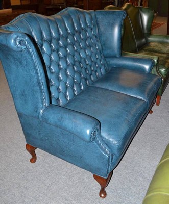 Lot 423 - Modern wing back two seater settee in blue leatherette with button back