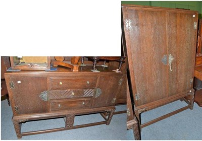 Lot 435 - A circa 1920s limed oak sideboard with carved detailing and similar two door cabinet on stand