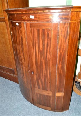 Lot 457 - Georgian mahogany inlaid hanging bow front corner cabinet