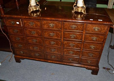 Lot 467 - Reproduction walnut and mahogany crossbanded chest of multi drawers