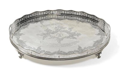 Lot 544 - An Edward VII Silver Tray, Thomas Bradbury & Sons, Sheffield 1909, oval, raised on four cast scroll