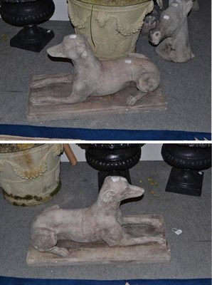 Lot 574 - A pair of reconstituted stone greyhounds