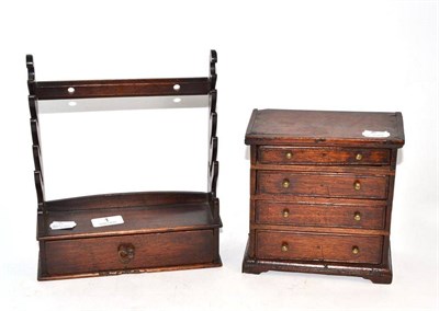 Lot 1 - A miniature chest of drawers and a miniature rack