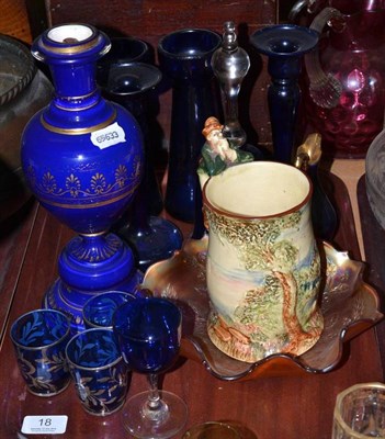 Lot 18 - A tray of blue glass, lamp base, carnival glass bowl and a musical mug