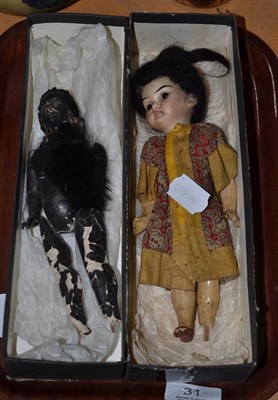 Lot 31 - Oriental bisque socket head doll with composition body (a.f.), papier mache 'negro' doll (2)