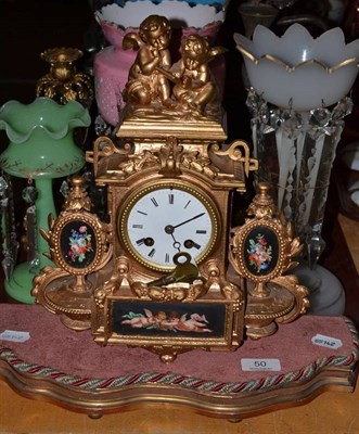 Lot 50 - A gilt metal mounted figural mantel clock with enamel dial on a wooden base