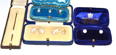 Lot 61 - A pearl stick pin, cased; a set of three pearl studs (cased), four pearl buttons and two pearl...