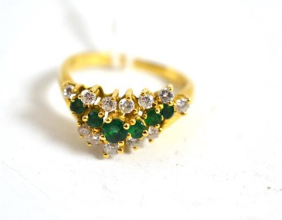 Lot 96 - An emerald and diamond three row ring